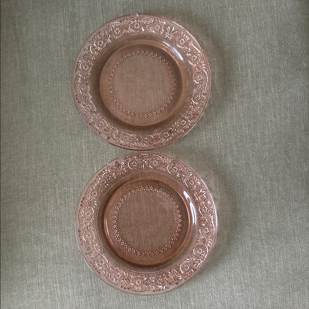 Pink depression glass plate. One has a small chip .